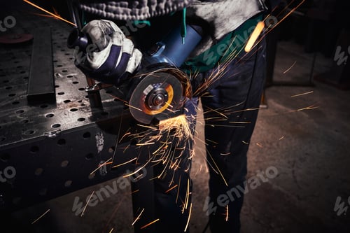 Preview: Heavy Industry Worker Cutting Steel With An Angle Grinder