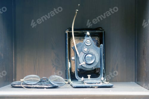 Preview: Vintage Camera And Glasses Are On A Shelf In A Retro Wardrobe