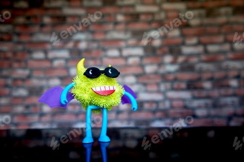 Preview: A Coronavirus Toy Figure With Glasses And Wings On Its Back.