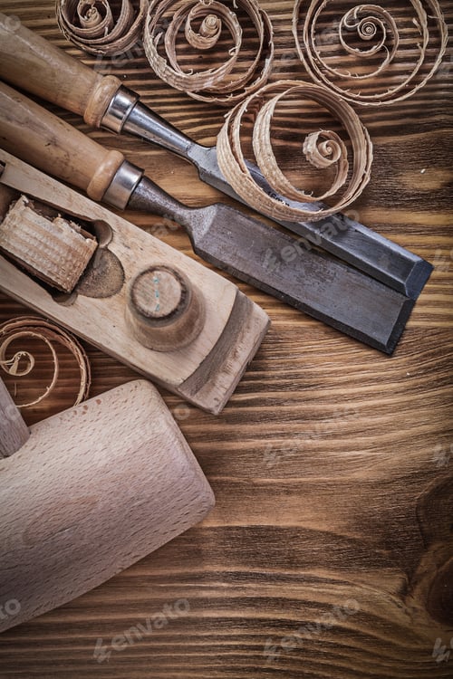 Preview: Firmer Chisels Shaving Plane Curled Shavings Wooden Mallet On Wood Board Construction Concept.
