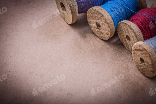 Preview: Reels Of Sewing Threads On Vintage Background.