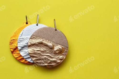 Preview: Gold, Silver And Bronze Medals On A Fashionable Yellow Background