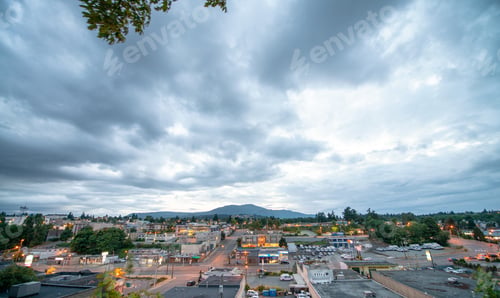 Preview: Small Town Skyline At Sunset Against Cloudy Sky.
