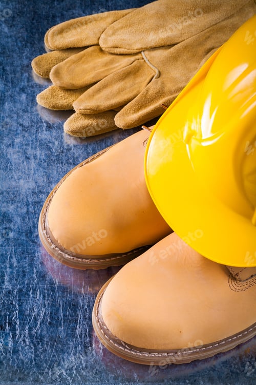 Preview: Pair Of Waterproof Boots Leather Gloves And Working Helmet On Scratched Metallic Surface