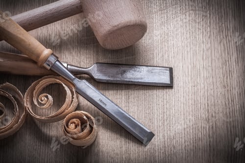 Preview: Wooden Hammer Planning Chips Flat Chisels On Wood Board Top View Construction Concept.
