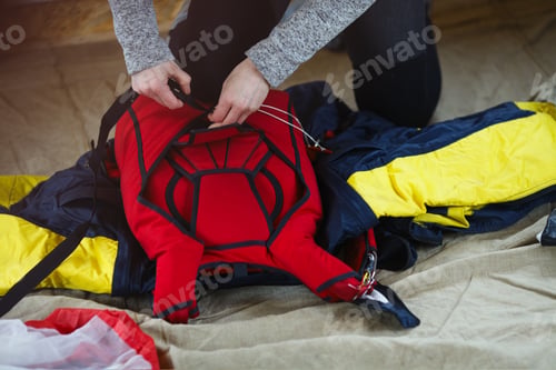 Preview: The Hands Of A Woman Skydiver Packing A Parachute, Face Is Not Visible, Close-Up.