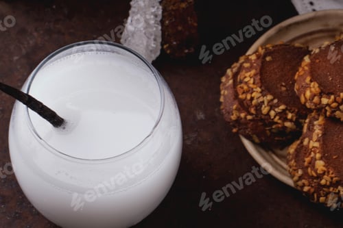 Preview: A Glass Of Home Made Rice Milk Served With Brown Rice, Honey And Organic Sugar Candies On A Rustic