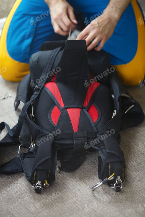Preview: Skydiver Packs A Parachute, Close-Up, Face Is Not Visible. Parachute Equipment.