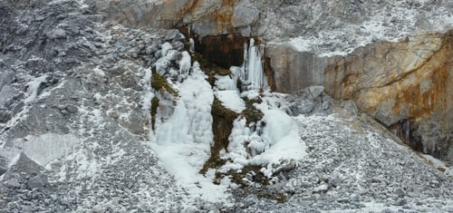 Preview: Beautiful Texture Of The Stone Surface In Winter Cloudy Day With A Layer Of Ice From Behind A
