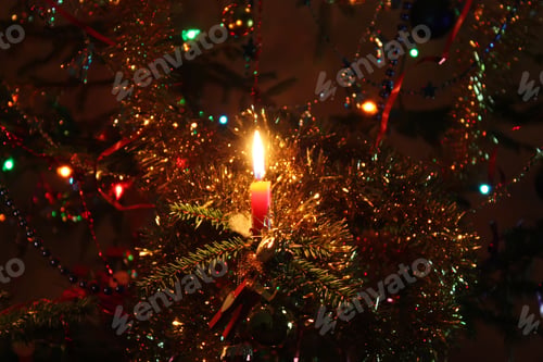 Preview: Warm Light Of Burning Colorful Candle Flame On Christmas Tree Background..