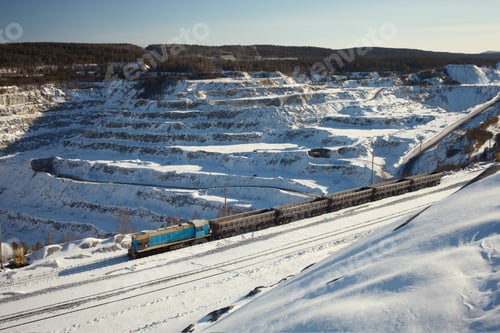 Preview: Locomotive With Several Cargo Platforms On The Background Of A Snow-Covered Stone Quarry On A