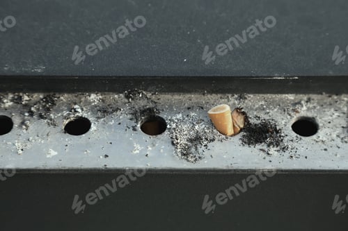 Preview: Cigarettes In Metal Outdoors Ashtray. Cigarette Butts Outdoors Closeup. Focus On Cigarette Butt