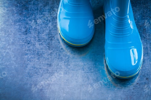 Preview: Pair Of Waterproof Gumboots On Scratched Metallic Background.