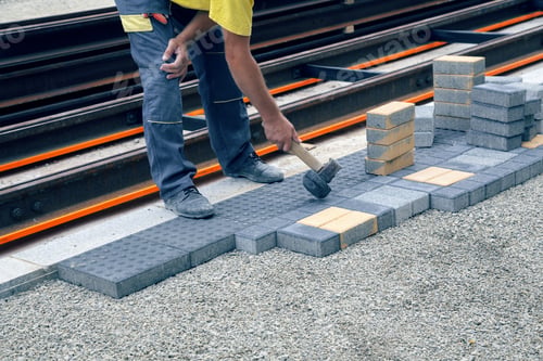 Preview: Worker Putting Down Patio Pavers On The Sidewalk During Sidewalk Reconstruction. Vintage Style.