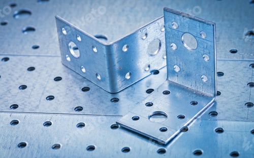 Preview: Stainless Drilled Angle Bars On Perforated Metallic Background Construction Concept.