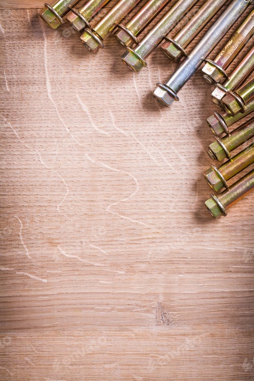 Preview: Vertical Version Gold Colored Metalic Anchors For Concrete Wall On Wooden Board With Organized
