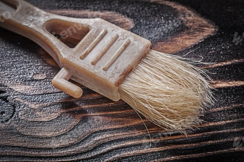 Preview: Obsolete Paint Brush On Wooden Board Top View Construction Concept.