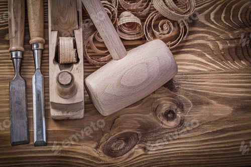 Preview: Chisels Shaving Plane Shavings Wooden Mallet On Wood Board Construction Concept.
