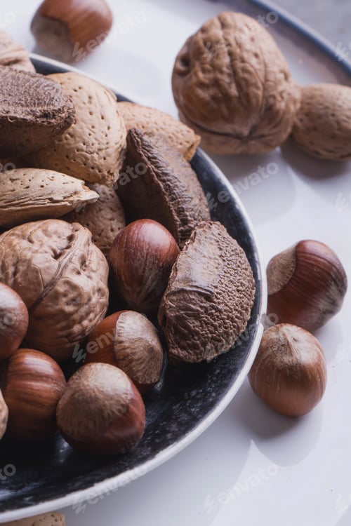 Preview: Selection Of Almonds In The Vintage Ceramic Plate, Black Background, Top View