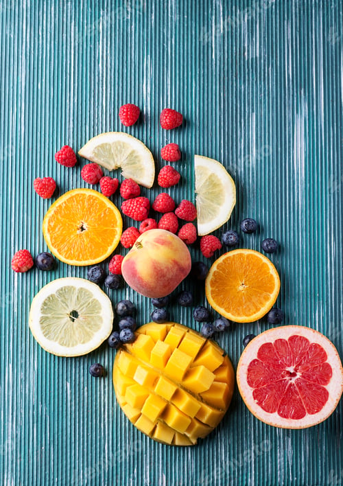 Preview: Slices Of Fresh Fruits Over Metal Blue Background. Top View