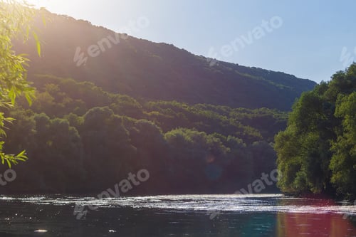 Preview: View Of The River In The Rays Of The Sunset. Toned Background Selective Focus.