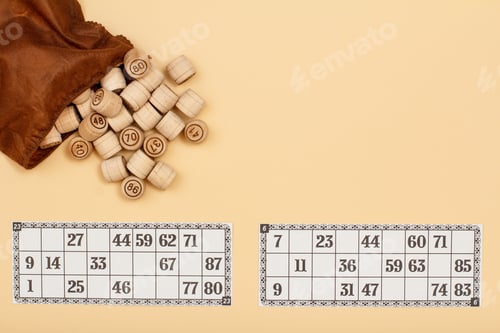 Preview: Wooden Lotto Barrels With Open Brown Bag And Game Cards On Beige Background. Board Game Lotto. Top
