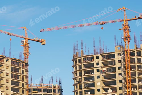 Preview: Building Crane And Building Under Construction Against Blue Sky