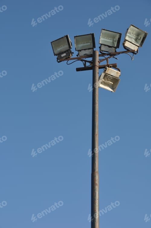 Preview: Stadium Lights Pole Against Blue Sky Background