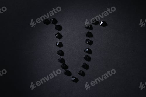 Preview: Symbol Of The Zodiac Sign Aries Made By Black Stones On A Black Background. Low Dark Key