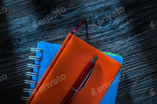 Preview: Composition Of Notepads Pen On Wooden Board.