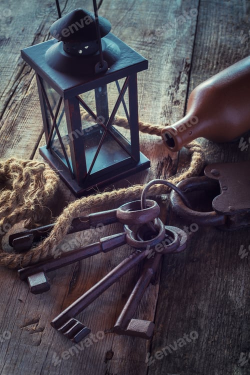 Preview: Old Rusty Lock With Keys, Vintage Lamp, Bottle From Clay And Rope On Wooden Board. Retro Stylized
