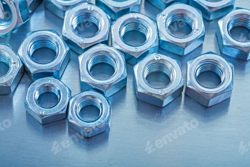 Preview: Close-Up View Of Screw Nuts On Metallic Background Construction Concept