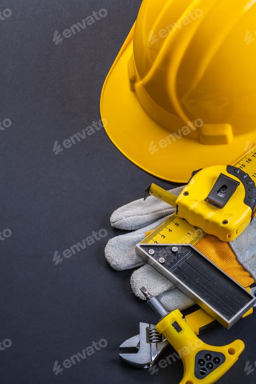 Preview: Helmet Square Ruler Tapeline Screwdriver Wrench Working Glove On Black Background