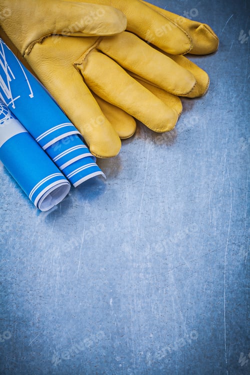 Preview: Leather Protective Gloves Blue Rolled Construction Plans On Metallic Background.