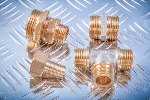 Preview: Brass Nipple Hose Connectors Equal Tee On Grooved Metal Background Plumbing Concept.