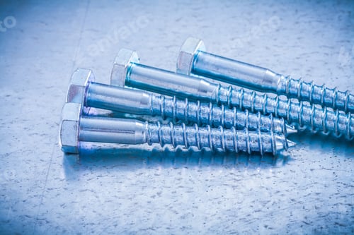 Preview: Close Up Of Metal Screw Bolts On Metallic Background Construction Concept.