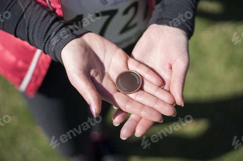 Preview: Young Woman Is Holding Medal In The Hands.