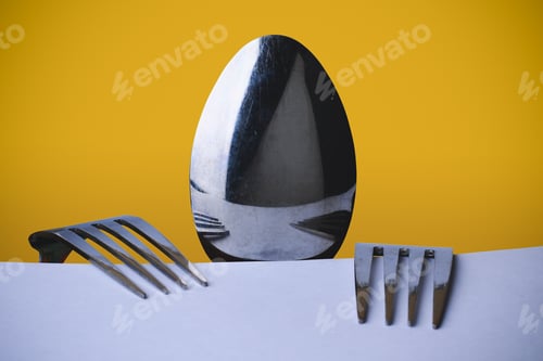 Preview: A Spoon And Two Forks Metaphorically Depict A Hungry Man Sitting At A Table. Conceptual Abstraction