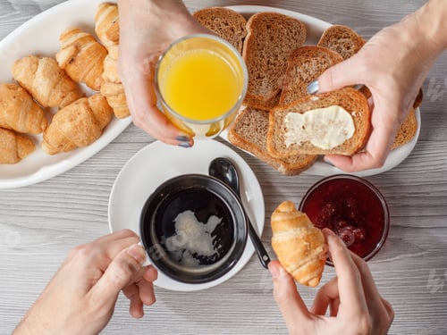 Preview: Male And Female Hands With Cup Of Black Coffee And Glass Of Orange Juice. Croissants, Bread, Glass