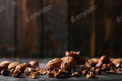 Preview: Varieties Of Nuts: Almonds, Hazelnuts And Walnuts Over Dark Texture Background