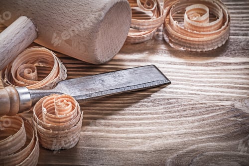 Preview: Wooden Hammer Firmer Chisels Curled Shavings On Vintage Wood Board Construction Concept.