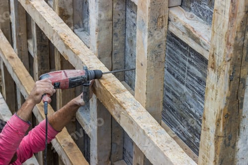 Preview: Construction Worker Using Drill, Working On Setting Formwork At The Building Site