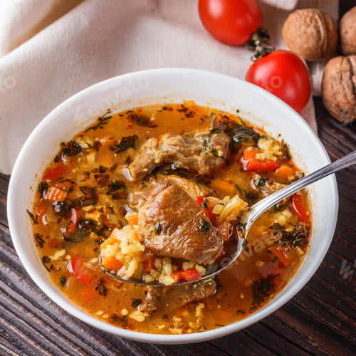 Preview: Georgian Soup. Kharcho With Rice, Tomato, Beef, Garlic And Herbs In Bowl On Wooden Table