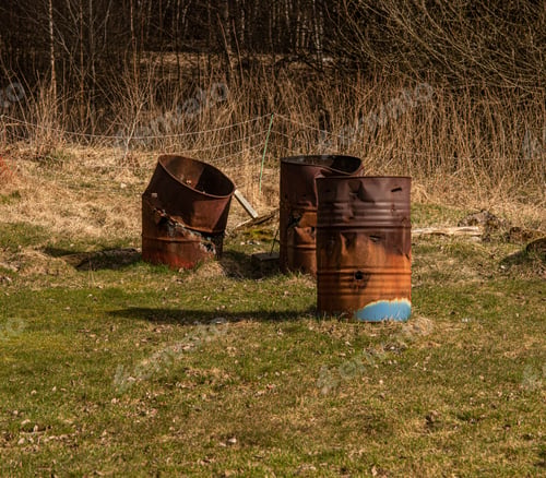 Preview: Three Burnt Out Metal Barrels In A Field