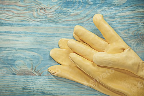 Preview: Yellow Leather Working Gloves On Wooden Board Construction Concept.