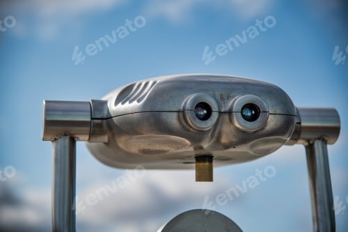 Preview: Shiny Binocular Telescope Against Blue Sky.