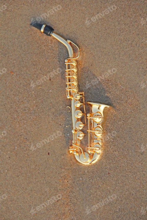 Preview: The Golden Alto Saxophone Lies On The Sand Or On The Beach. Musical Cover And Creative. Design With