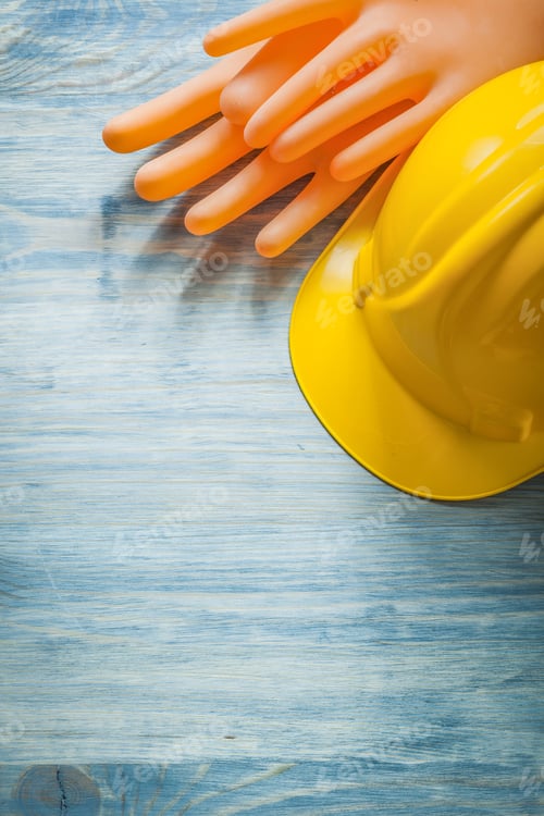 Preview: Composition Of Dielectric Gloves Building Helmet On Wooden Board Electricity Concept.