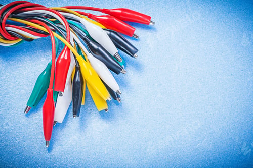 Preview: Assortment Of Electric Crocodile Clip Cables On Blue Background Electricity Concept.