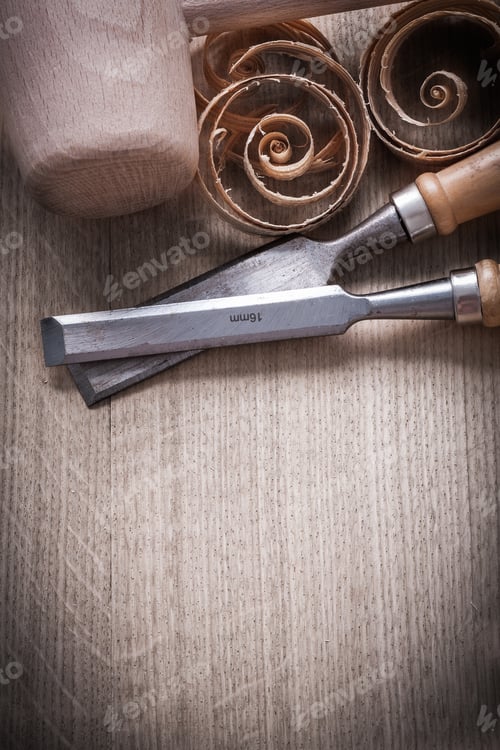 Preview: Wooden Hammer Planning Chips Flat Chisels On Wood Surface Construction Concept.